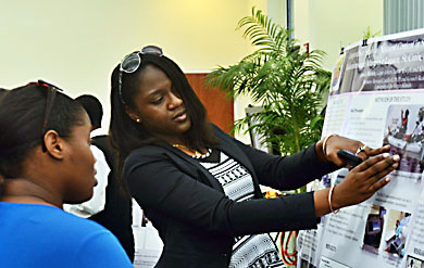  Jamila Martin, a UVI senior majoring in applied mathematics, gives a poster presentation on the UVI Saint Thomas Campus