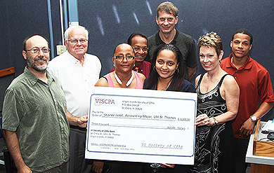 Rob Upson  and Dr. Sherri Levin, of the Virgin Islands Society of Certified Public Accountants, presents UVI Accounting Student Shanee Isaac with a scholarship, while UVI staffers Dr. Stephen Reames, UVI Dean of the School of Business, Dr. James S. Maddirala and Dr. Dion Gouws  stand in the background.    