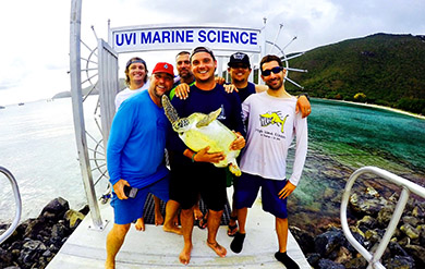 A Group of Students from the Turtle Club Pose with a Turtle