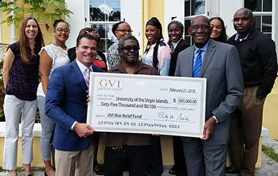 UVI's President David Hall Receives Check from Philip Arcidi, Owner of Greenleaf VI II. Inc.