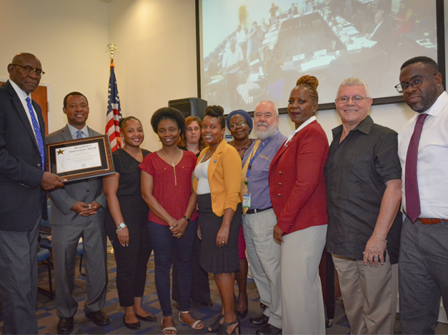 staff of institutional advancement receiving presidential award from president david hall