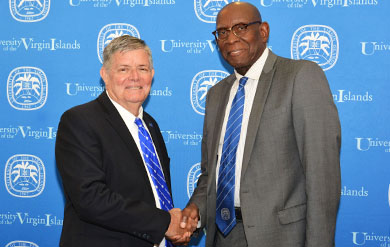 UVI Board Chairman Henry Smocks congratulates UVI President David Hall