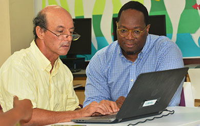 Dr Boumedine and Dr Kinsy view information on computer screen