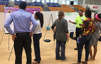 UVI student discuss their research at the Fall Research Symposium.